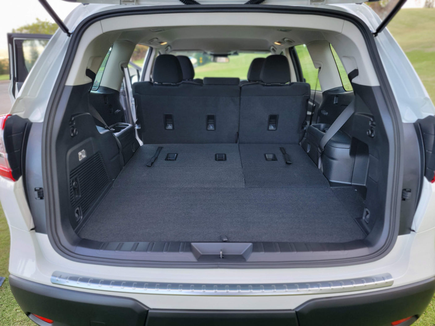 Spacious SUV cargo area with folded seats offers versatile storage for an RV rental trip, with plenty of room for luggage and gear.