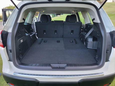 Spacious SUV cargo area with folded seats offers versatile storage for an RV rental trip, with plenty of room for luggage and gear.
