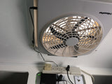 RV rental ceiling fan, power strip, and electronics are seen, providing comfort and connectivity in a compact space.