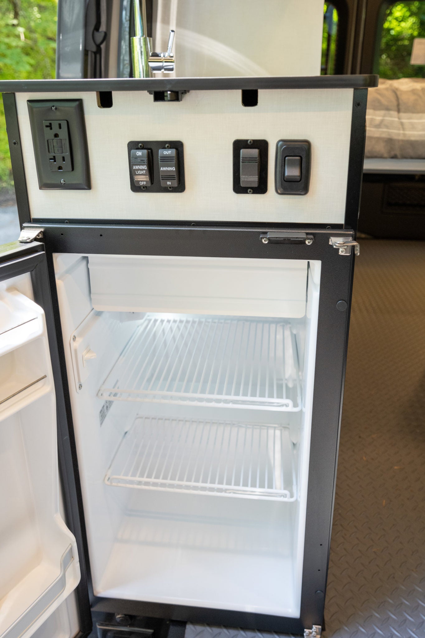  revealing interior. Perfect for outdoor adventure.|This RV rental features a handy pop-out table for outdoor meals — photo 4