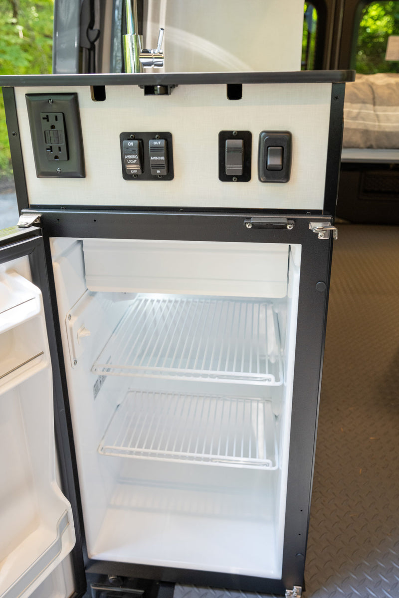  revealing interior. Perfect for outdoor adventure.|This RV rental features a handy pop-out table for outdoor meals — photo 4