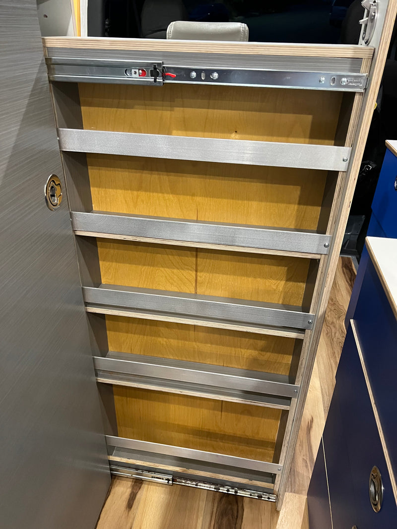 RV rental: A pull-out pantry with plywood shelves & metal retaining bars on heavy-duty slides for secure storage. — photo 20