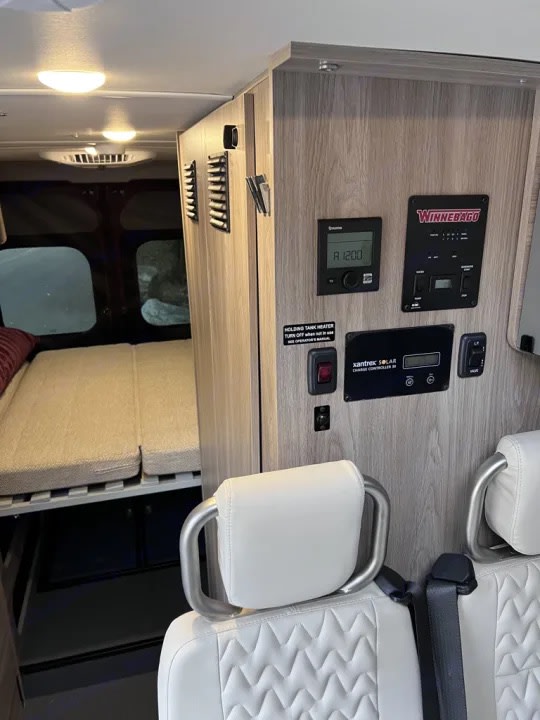  ready for a serene nature road trip adventure.|RV rental interior: control panel with tech displays — photo 2