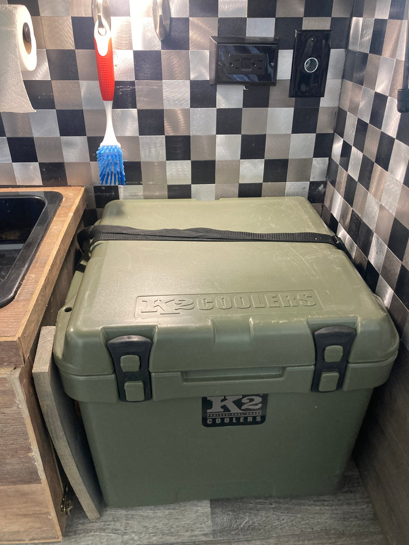 Green K2 Cooler and sink in a compact rv rental kitchen, featuring a distinctive checkered backsplash. — photo 10