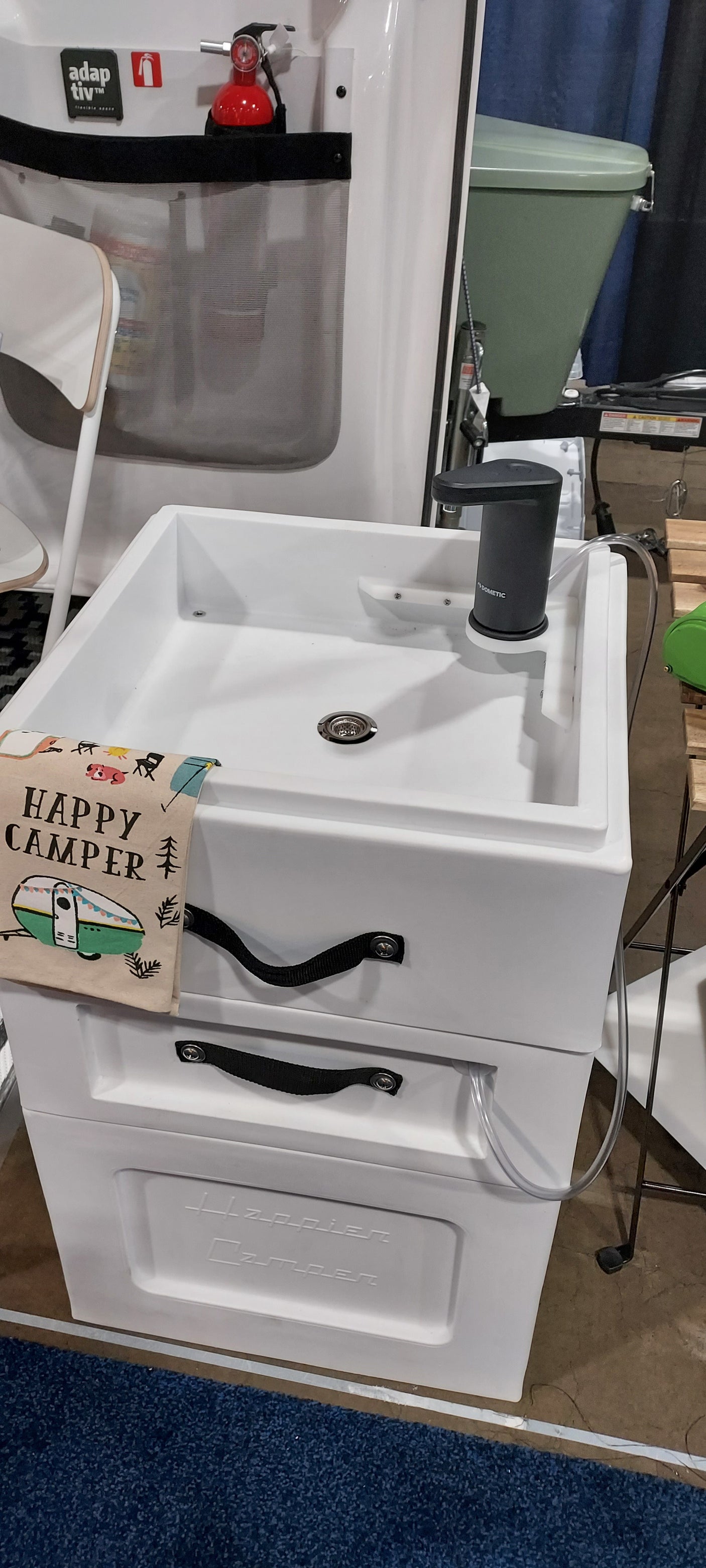 This portable sink unit by Happier Camper, featuring a Dometic faucet, offers a compact kitchen solution for any rv rental.