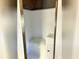 This RV rental features a compact, all-in-one bathroom with a toilet, sink, and shower enclosure for convenience.