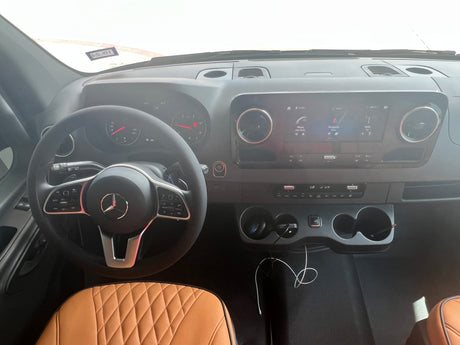 Mercedes-Benz RV rental interior: Modern dashboard, steering wheel, infotainment, and quilted seats for a comfortable journey.