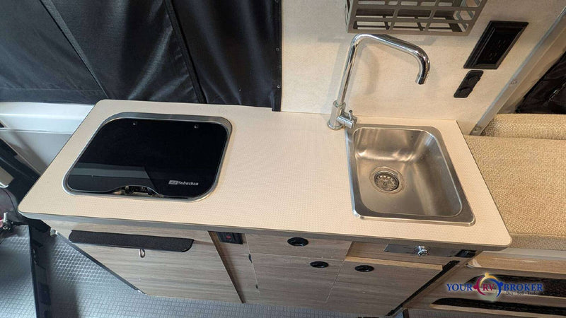  & a front passenger seat in this camper van.|RV rental interior: Kitchenette with sink/cooktop — photo 6