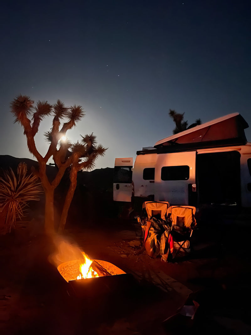  under a cloudy sky. Ideal for nature adventures.|White RV rental parked in a rugged desert landscape among massive rock formations under a clear blue sky.|A white pop-top RV rental and a tan dog stand on green grass at sunset — photo 32