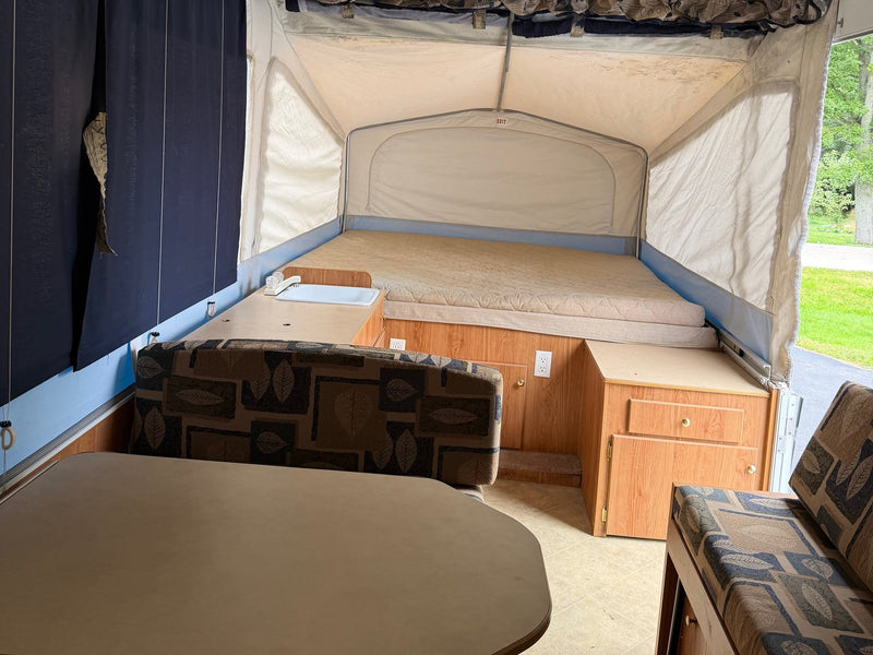  is set up on a driveway with an outdoor stove and table.|White Jayco Jay Series 1006 pop-up rv rental — photo 3