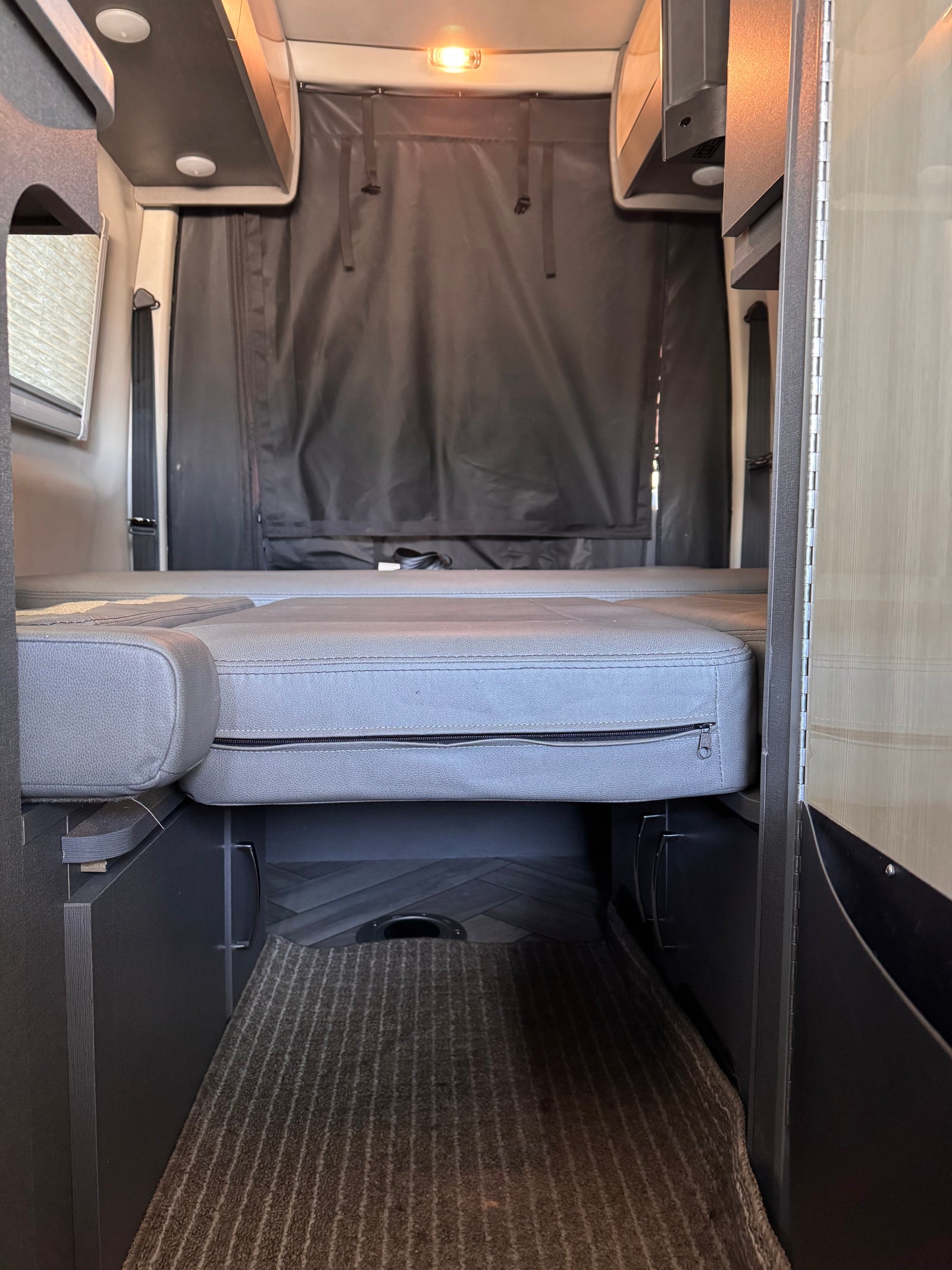 Experience comfort in this RV rental with its convertible bed, overhead storage, and rear privacy curtain.