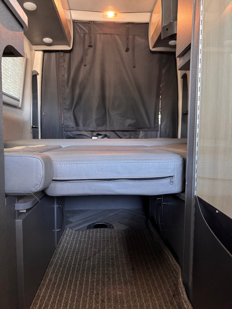 Experience comfort in this RV rental with its convertible bed, overhead storage, and rear privacy curtain.