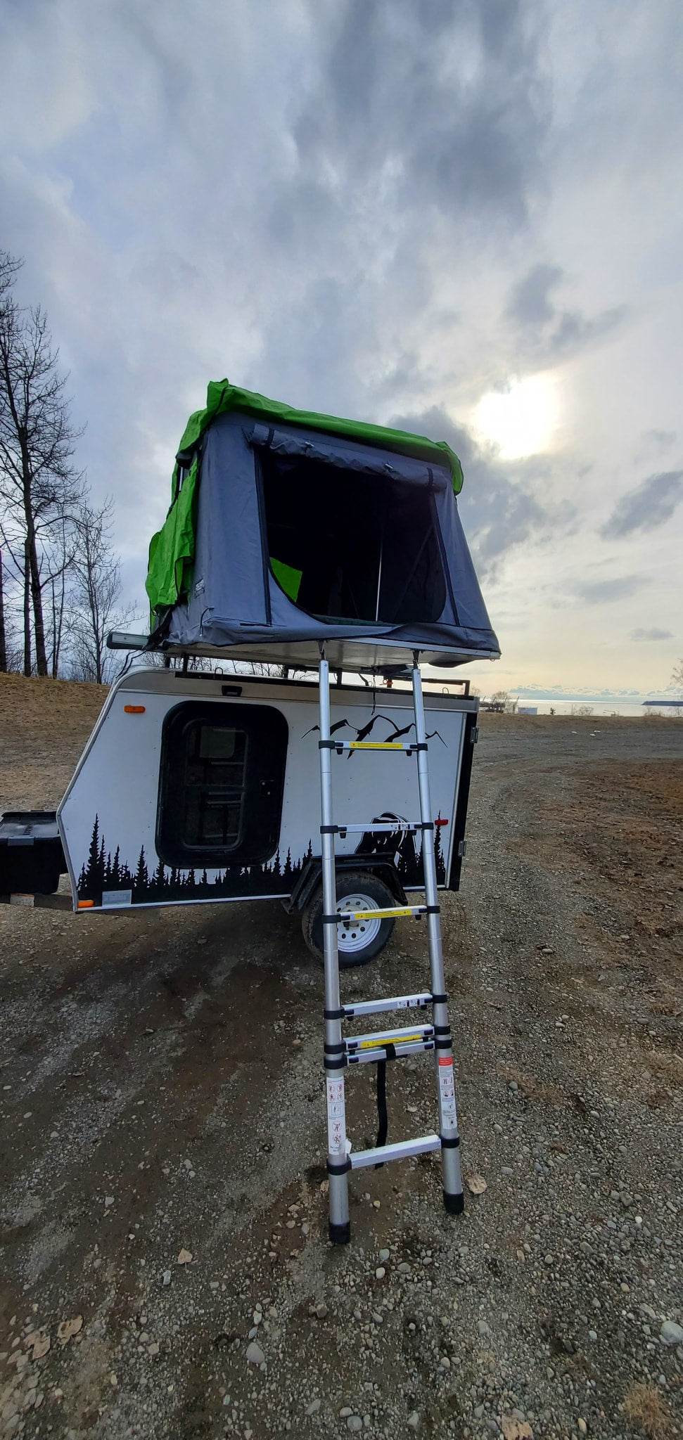 RV rental: A compact travel trailer with a deployed rooftop tent and ladder is ready for outdoor camping adventures. — photo 11