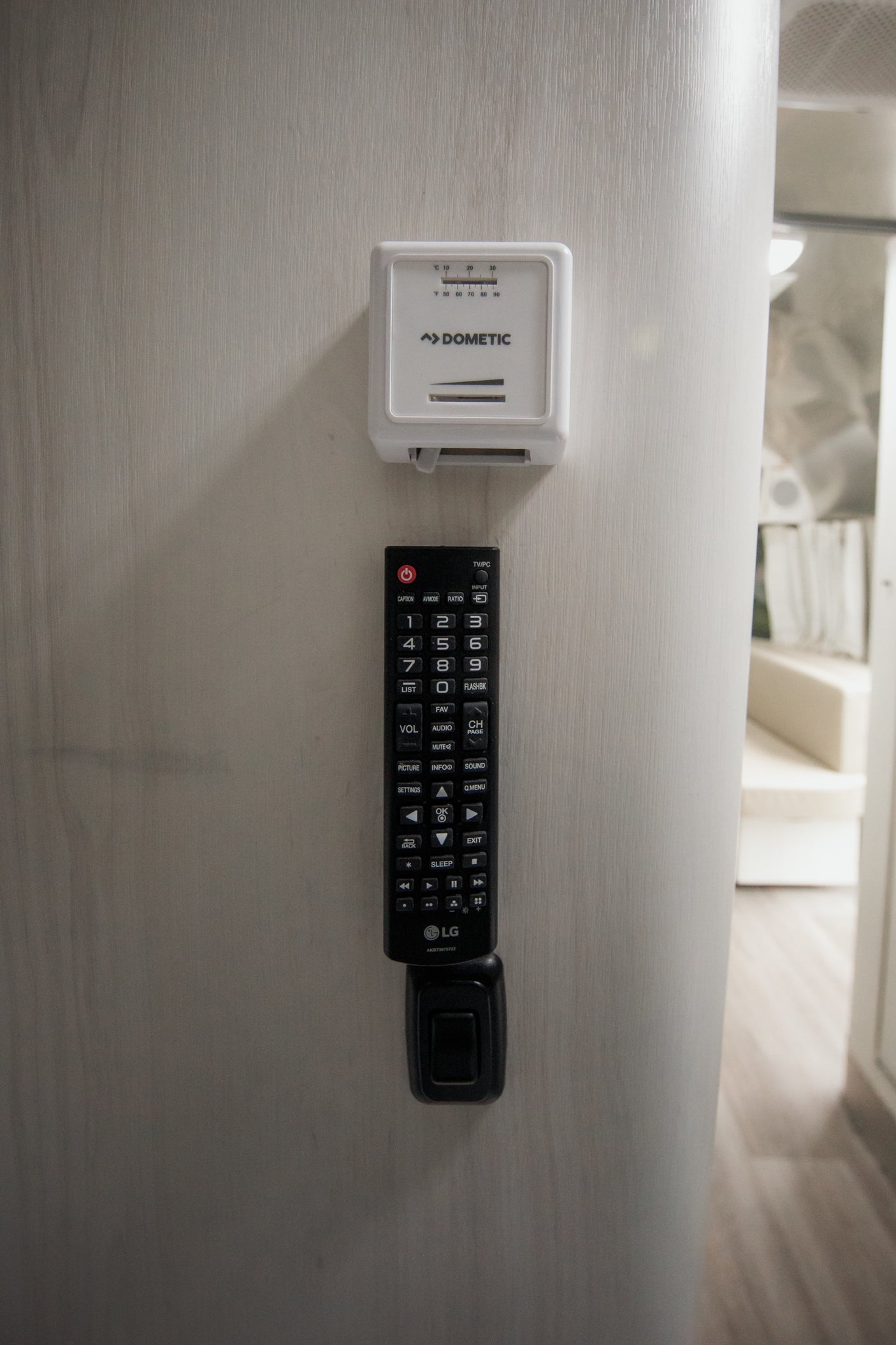 Control your comfort in this rv rental with the Dometic thermostat and LG remote mounted on the wall.