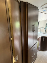 Stylish RV rental interior with dark wood cabinetry, a modern kitchen, and light tiled floor.