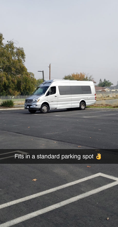 This silver Mercedes Sprinter RV rental fits into a standard parking spot, highlighting its compact and practical design.