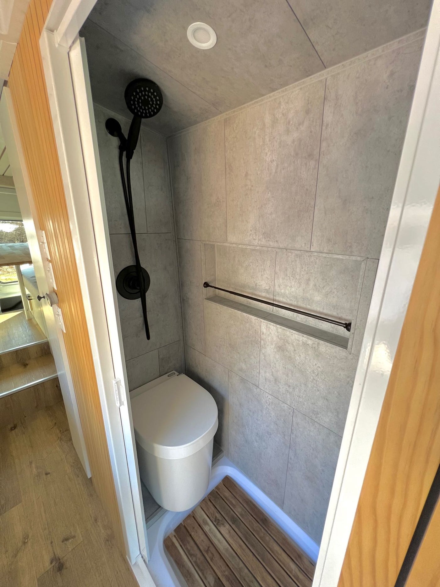  and a white countertop.|Cozy RV rental bedroom with a stunning desert landscape view from the back windows