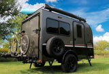 Adventure-ready RV rental: a compact travel trailer with bikes & kayak, set up for outdoor exploration.