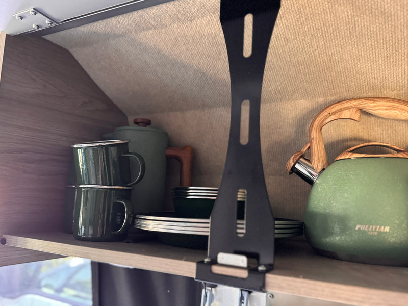 Organized RV rental kitchen shelf with green enamel mugs, plates, teapot, and kettle. Perfect for camping adventures. — photo 12