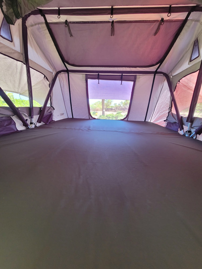 Experience comfort in this spacious rooftop tent interior, with a soft mattress and a scenic view. Ideal for your RV rental journey. — photo 17