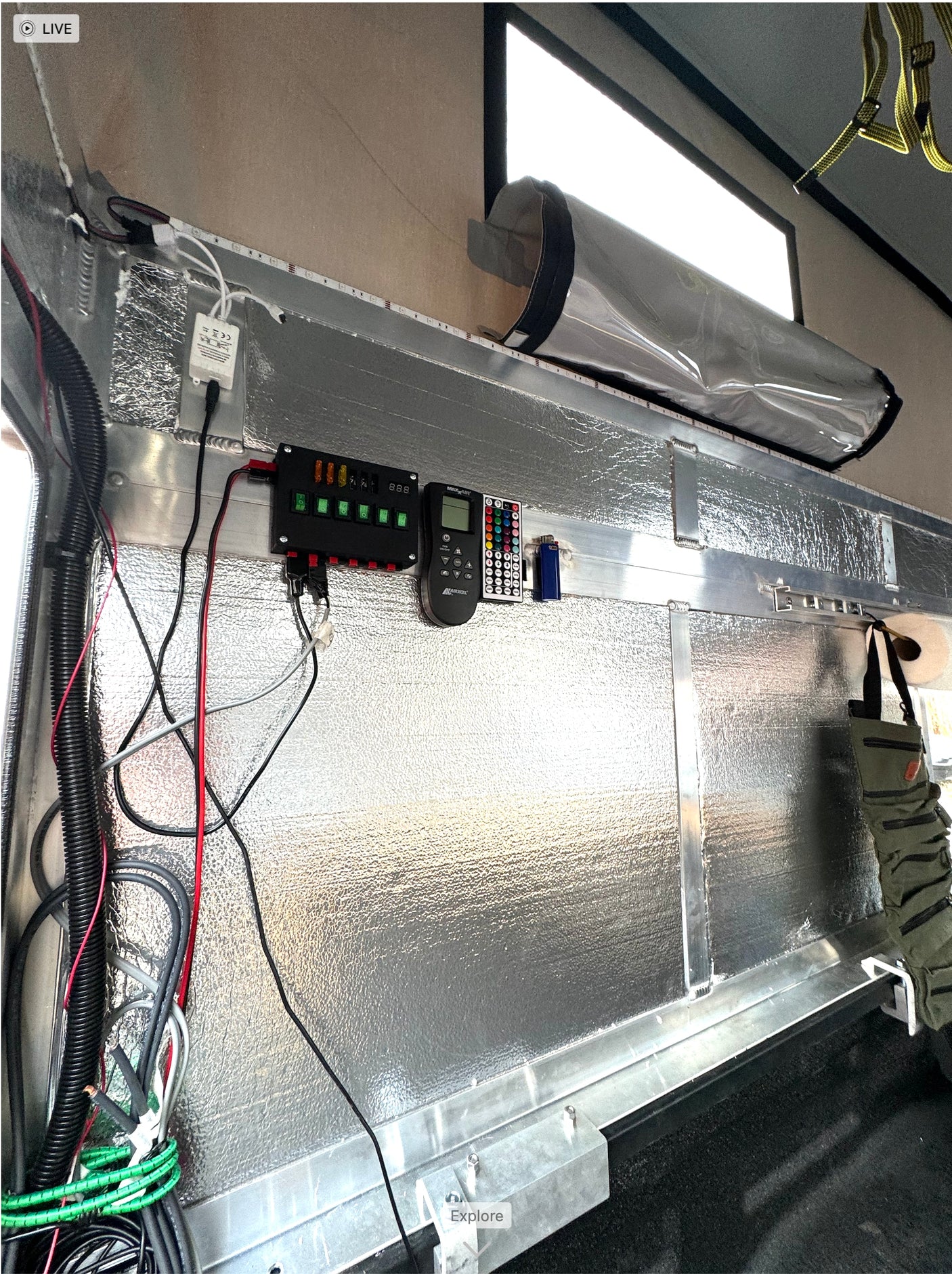 RV rental interior: custom electrical panel, LED lights, and insulated walls for van life comfort.