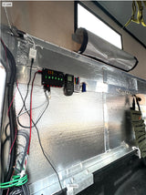 RV rental interior: custom electrical panel, LED lights, and insulated walls for van life comfort.