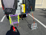 RV rental equipped with outdoor gear: TRASHAROO bag, jerry cans, and various sifting tools for beach adventures.