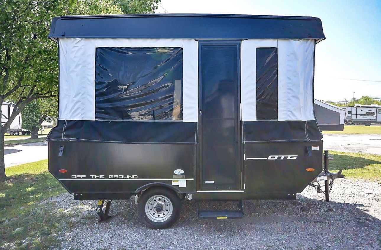 Experience camping with this compact pop-up camper, perfect as an rv rental, featuring an expanded side with windows & door.