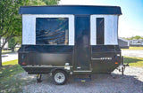 Experience camping with this compact pop-up camper, perfect as an rv rental, featuring an expanded side with windows & door.