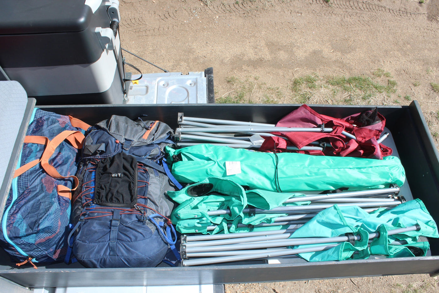  and water for overlanding.|This custom truck camper's open hatch reveals a pull-out kitchen with stove — photo 28