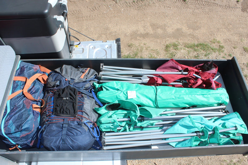  and water for overlanding.|This custom truck camper's open hatch reveals a pull-out kitchen with stove — photo 28