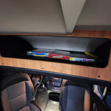 RV rental interior: storage of Scrabble, Sorry!, Scattergories games; driver's cabin view.
