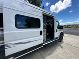 White National Park Foundation RV rental camper van with its side door open and step extended.