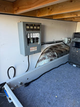 Inside an RV rental: electrical panel with labeled breakers, a portable power station, and sound insulation.