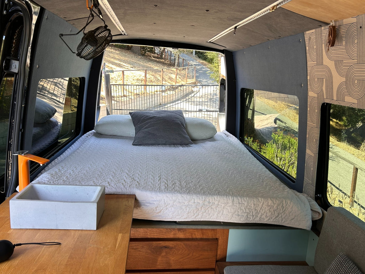  and flowers.|Cozy RV rental interior featuring a wooden table — photo 7