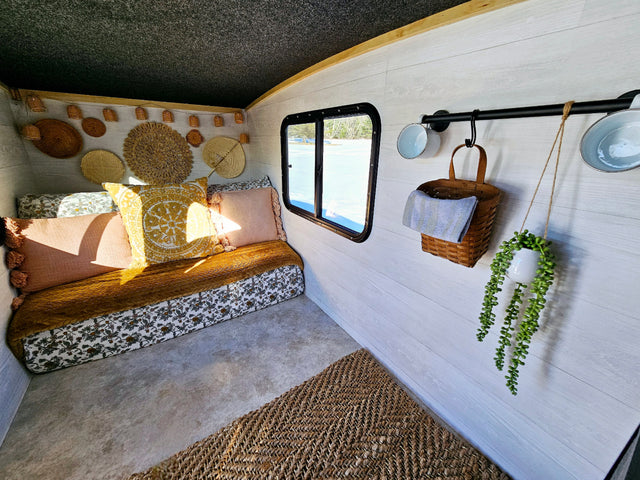 Cozy RV rental interior with a comfy daybed