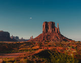  blue dishes on a table in a desert-like camp.|Vibrant desert sunset over a fully equipped car camping setup & huge mountains. Explore new rv rental adventures.|SUV transformed into a camper with a bed