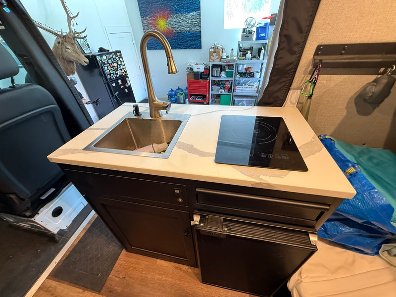 Functional RV rental campervan kitchen: sink, induction cooktop, fridge. Ideal for van life adventures. — photo 15