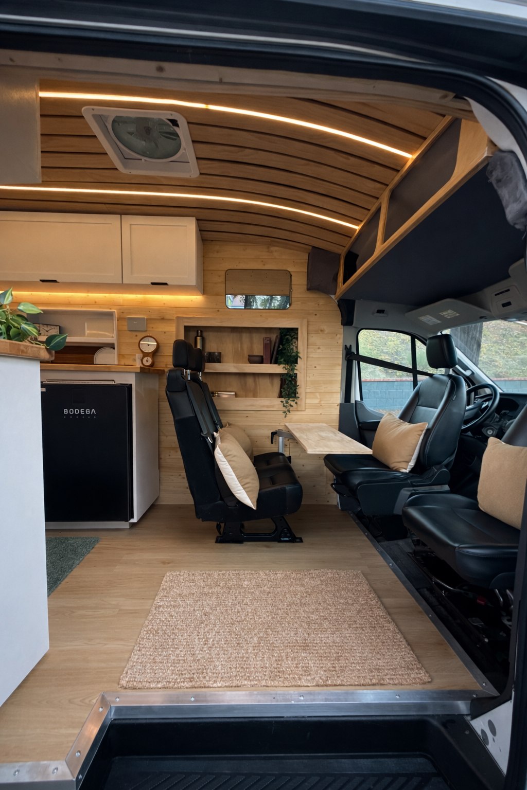  and storage drawers for compact living.|Inside a modern rv rental: wood-paneled walls — photo 3