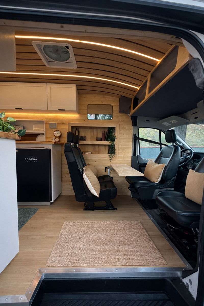  and storage drawers for compact living.|Inside a modern rv rental: wood-paneled walls — photo 3