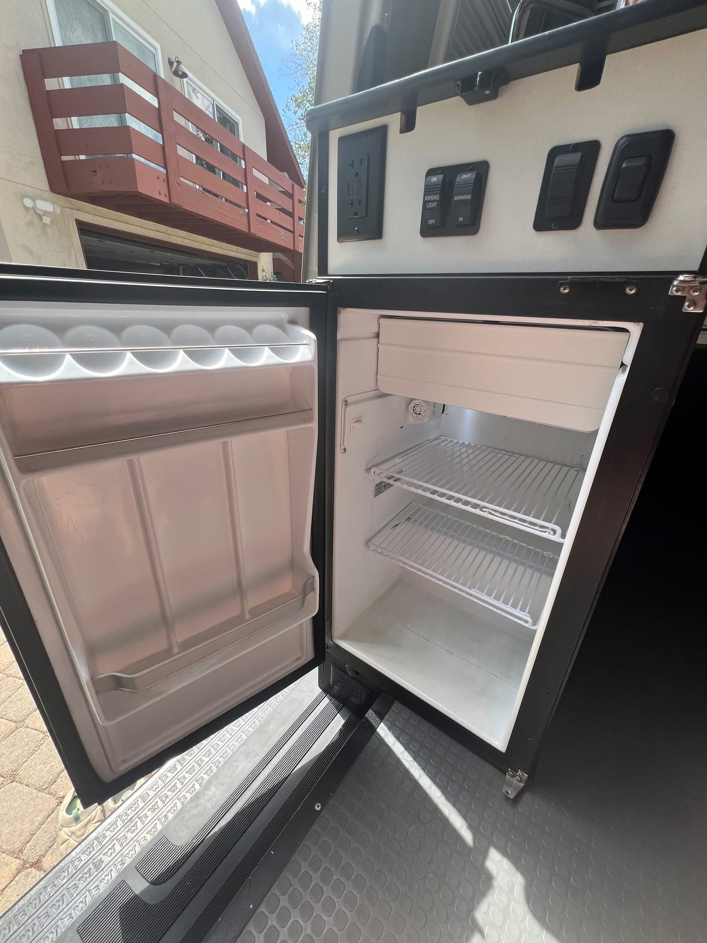  and rear storage system.|Compact RV rental wet bath featuring a shower — photo 12