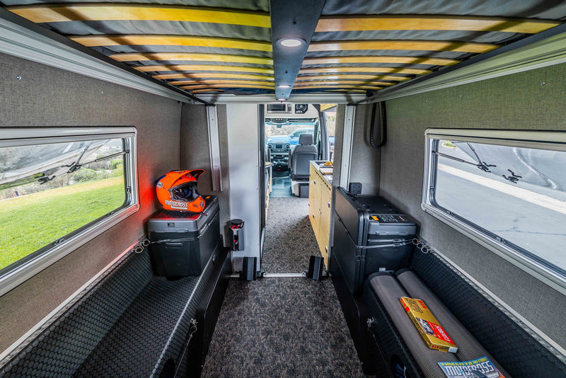  enjoying desert views with saguaro cacti. Laptop on bed for convenience.|Modern RV rental interior: kitchen — photo 11