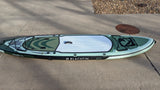 This green Blackfin Model XL inflatable paddleboard on concrete is ready for RV rental travel and water adventures.