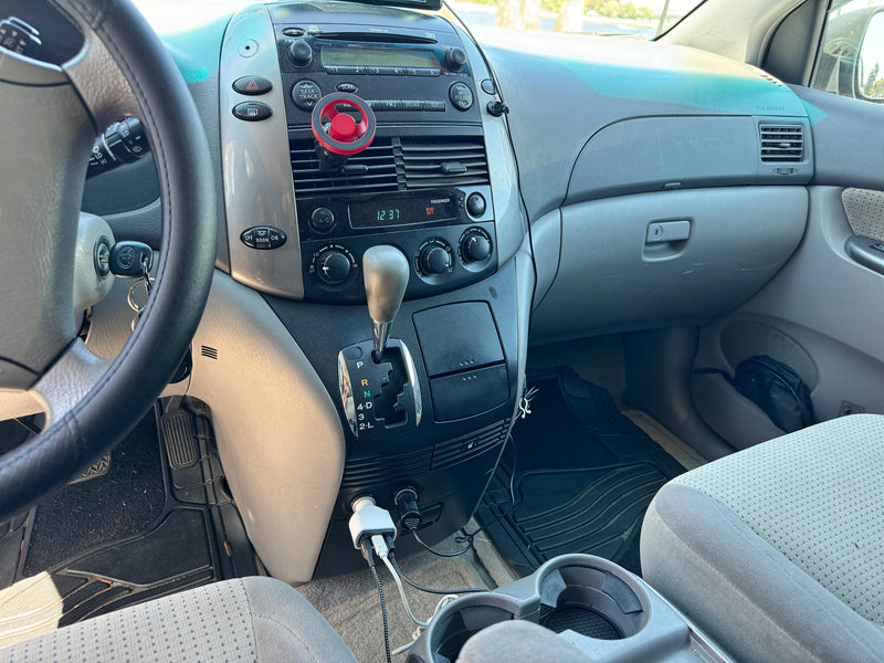 Spacious van interior: dashboard, steering wheel, auto gear shift. Gray seats & charging cables. Consider for your RV rental journey. — photo 6