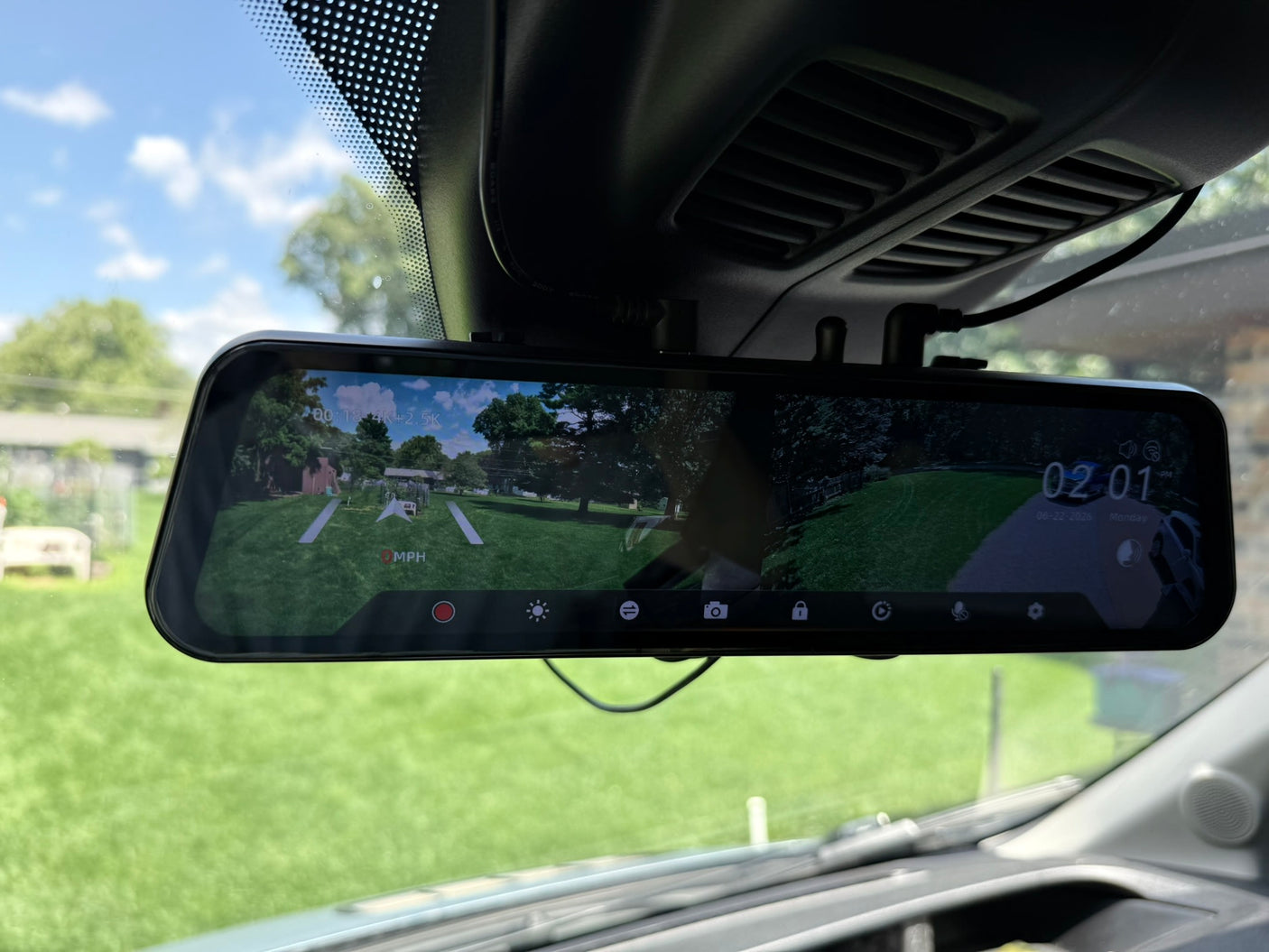  Dometic remote.|Gray RV rental camper van parked on a gravel driveway with an awning extended
