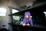 Happy child enjoys modular bunks in an RV rental, offering storage & sleeping space. Great for family road trips.