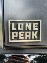 Durable "Lone Peak" emblem on an RV rental, hinting at scenic mountain journeys.