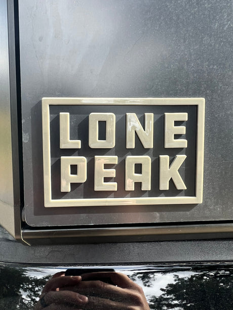 Durable "Lone Peak" emblem on an RV rental, hinting at scenic mountain journeys.