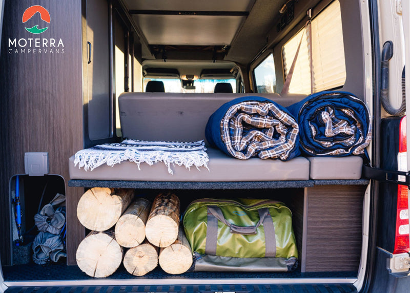 Organized RV rental campervan interior: storage with logs, gear, & comfy blankets for your next adventure. — photo 8