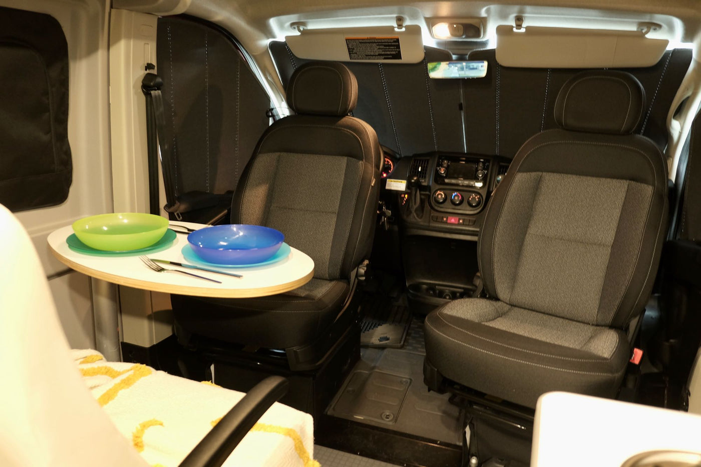  and supplies for on-the-go meals.|Inside an RV rental camper van: a cozy bed — photo 16